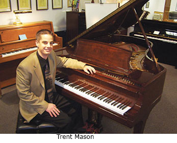 Trent Mason shows off a Steinway grand at M.Steinert & Sons,­ the country's second-oldest Steinway retailer