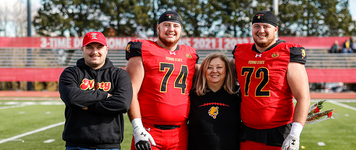 Photo of Anderson brothers with their parents on Senior Day