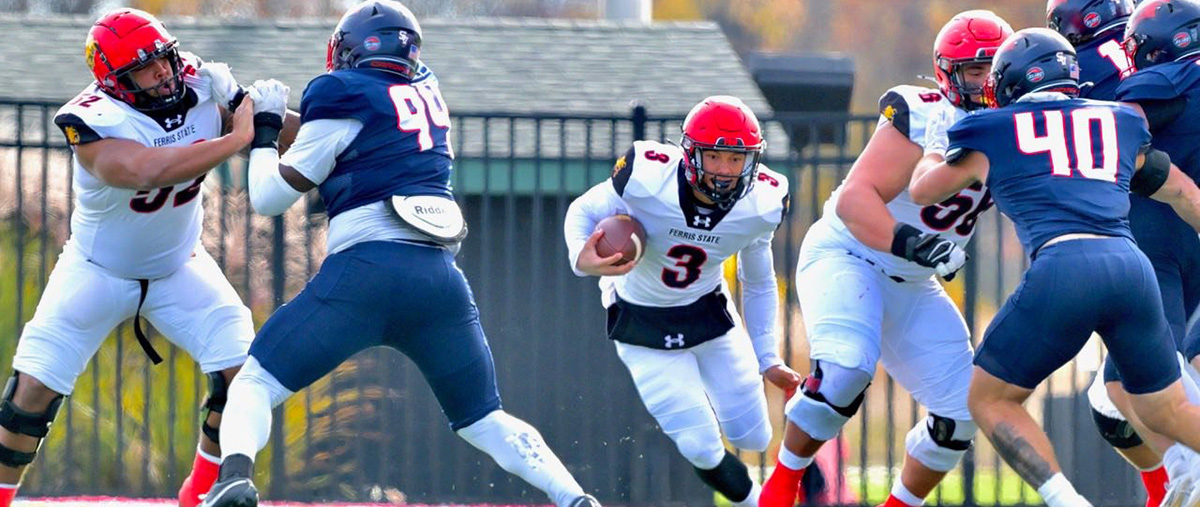 Ferris State player running with football.