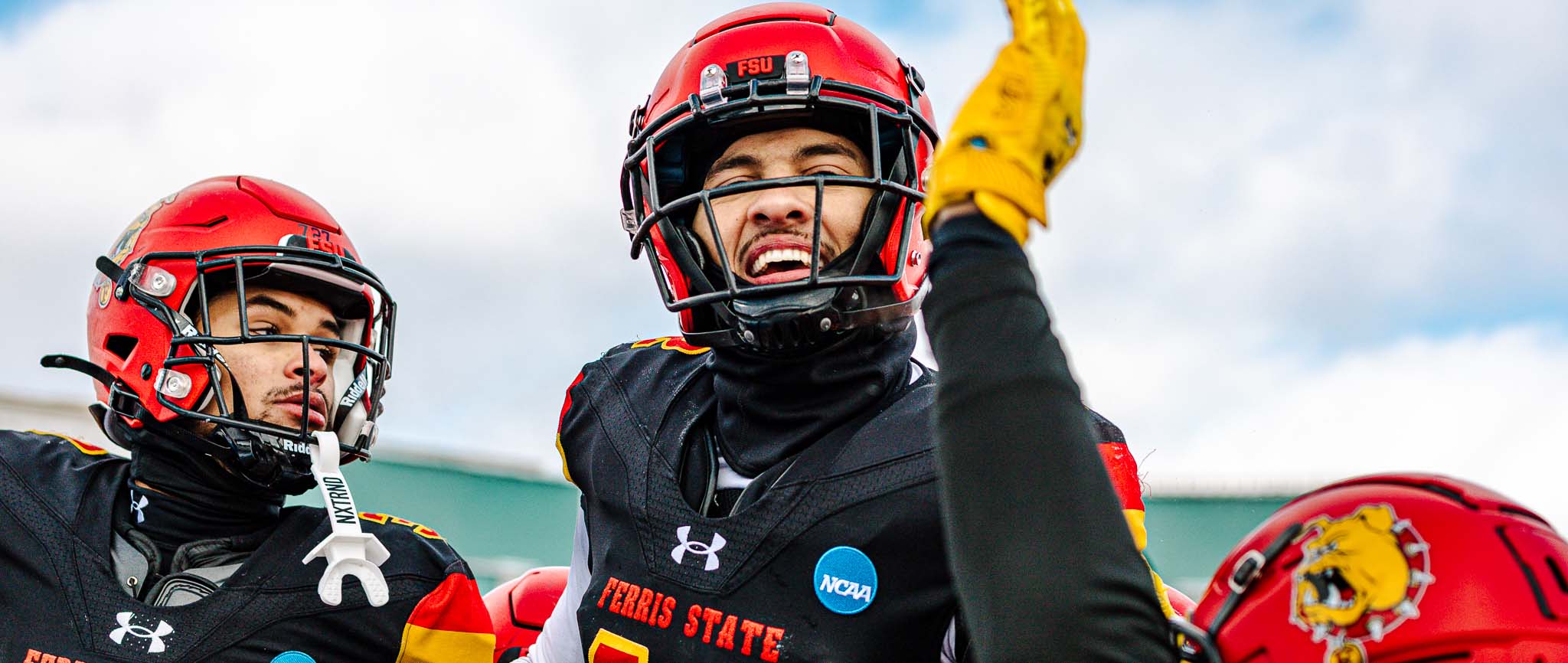 Eric Jackson (left) and Jalen Jones (center) celebrating with teammates