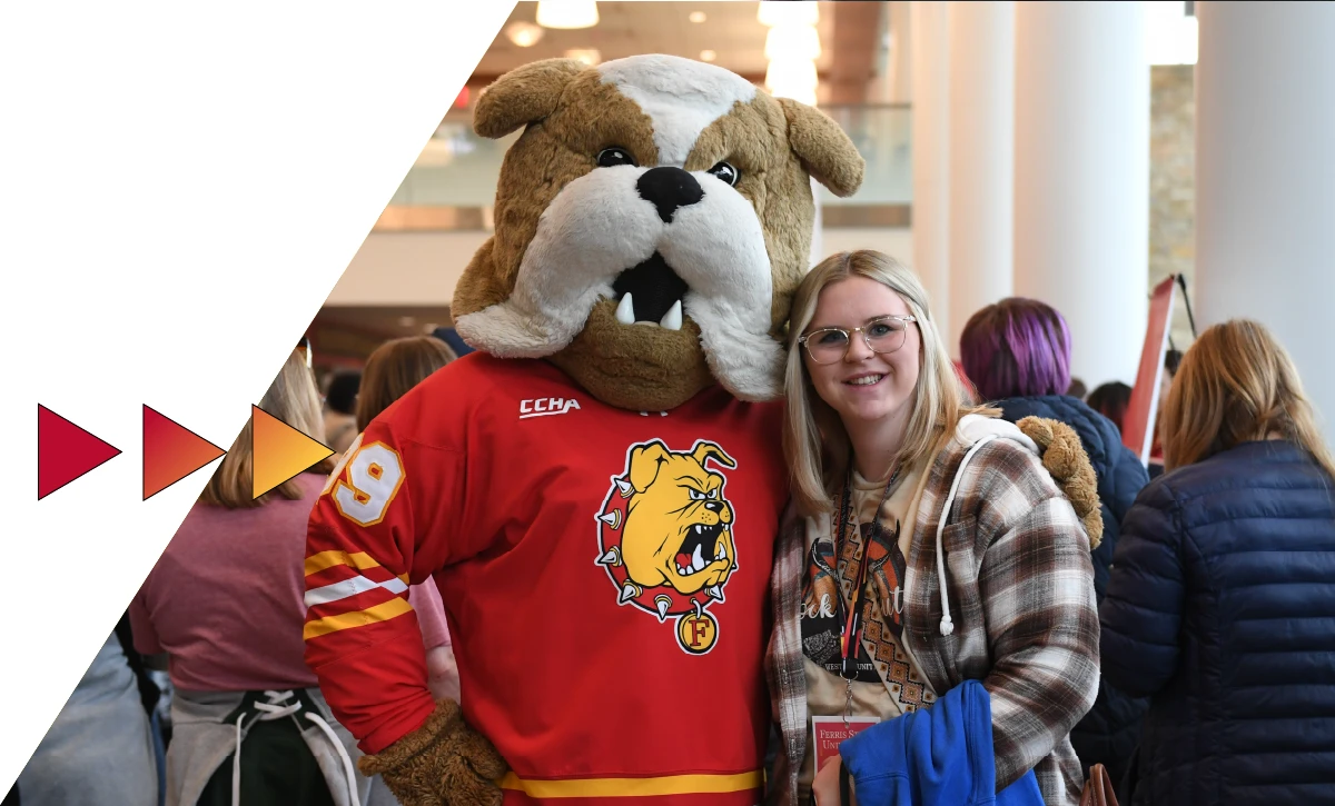 Student posing with Brutus the Bulldog mascot on the campus of Ferris State University in Big Rapids MI