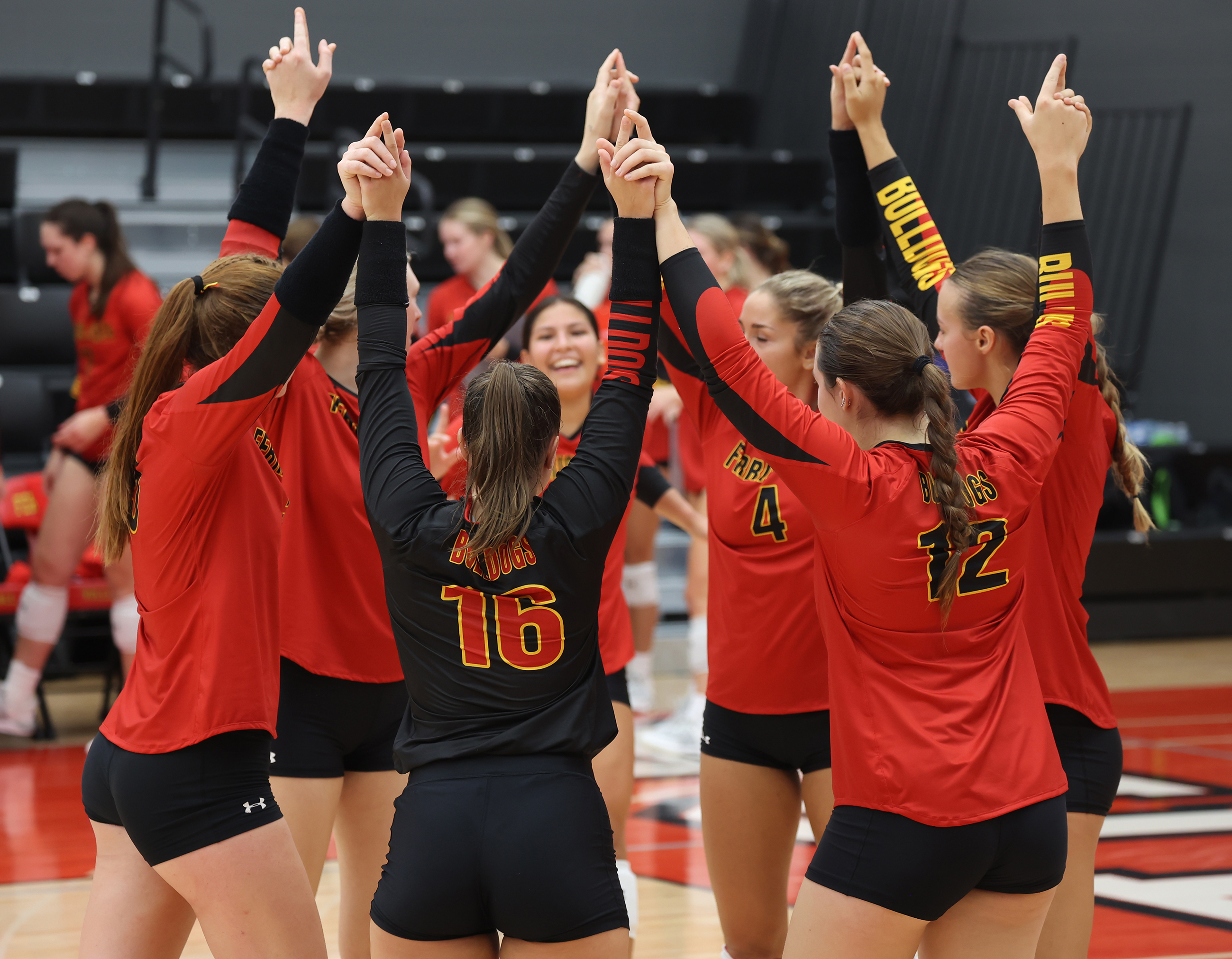 The Ferris State Volleyball Team huddles up prior to its season opening match against Thomas More on Friday, Sept. 1. This was the first officially volleyball match in the new Bulldog Arena.
