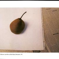 Lone Pear on White Paper with Newsprint