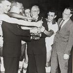 Basketball coach Jim Wink (far right) celebrates a championship with former Ferris president Victor Spathelf.