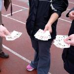 Picture of people holding up their poker hand.