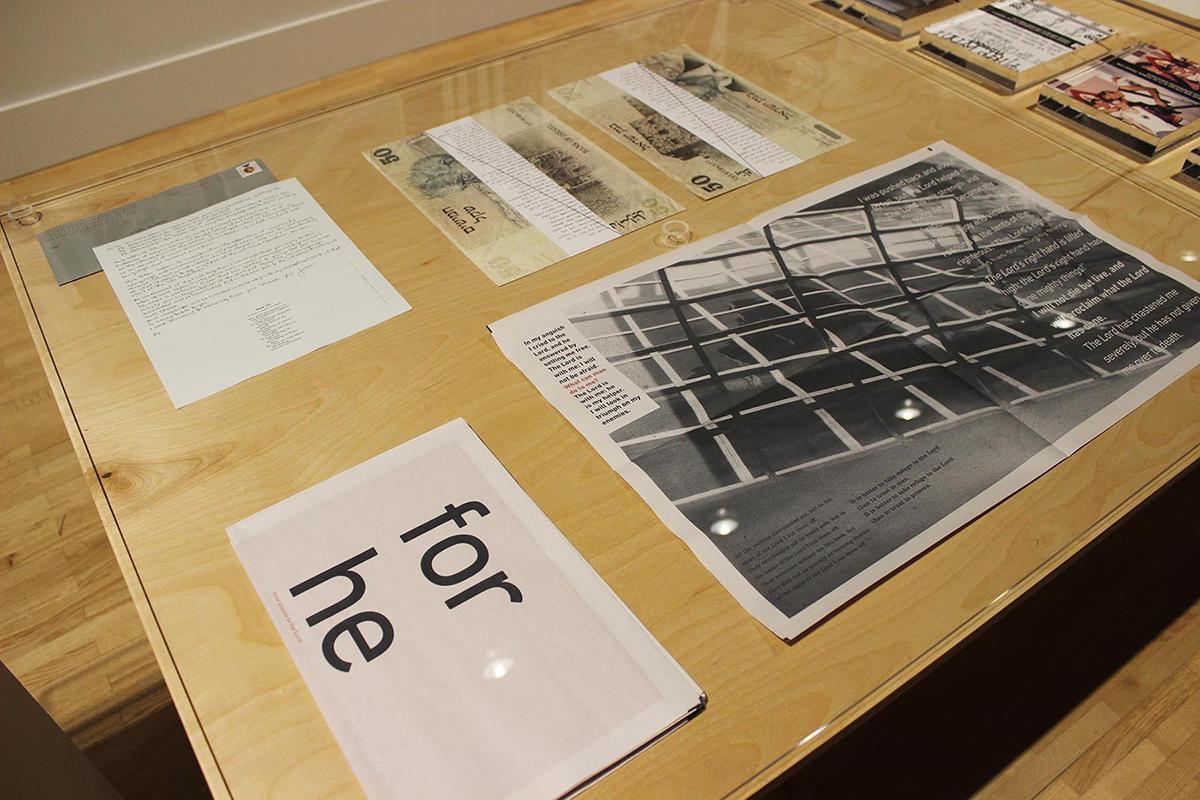 Graphic design pieces spread out under a glass tabletop.