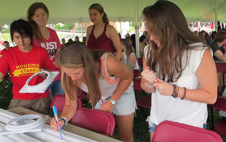 New students signing the column during Honors Convocation