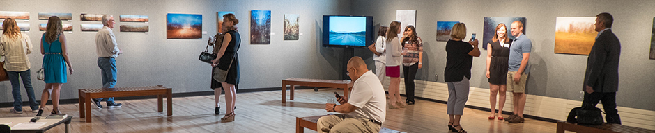 Honors students and parents browse the University Center's Art Gallery
