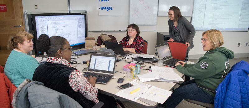 Jody Gardei teaching a group of women about document accessibility.