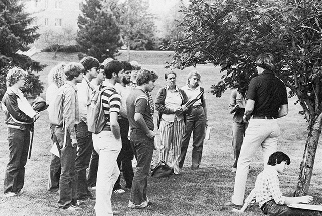 biology class examining a tree