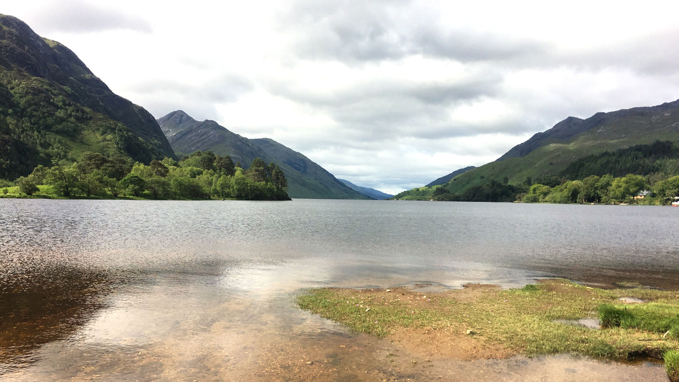 Image of loch and mountains in Scotland for travel website hero