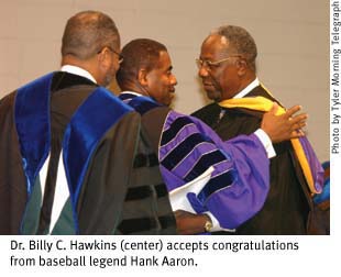Dr. Billy C. Hawkins accepts congratulations from baseball legend Hank Aaron
