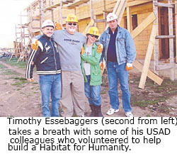 Timothy Essebaggers (second from left) takes a breath with some of his USAID colleagues who volunteered to help build a Habitat for Humanity 