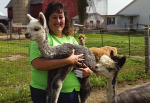 Nancy (Slagell) Rogers holding an alpaca