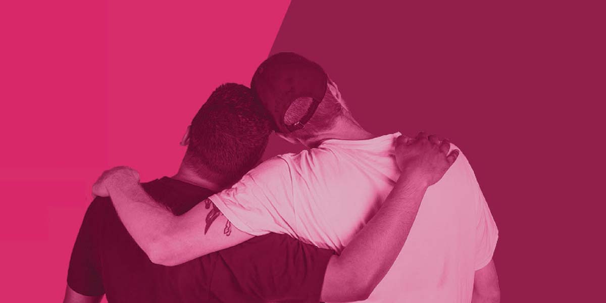 Couple with arms around shoulders