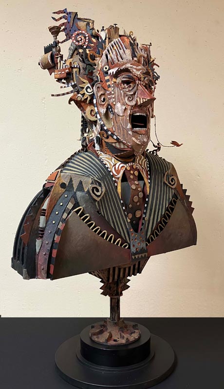 A sculpture of a male figure with its mouth open rendered from found objects