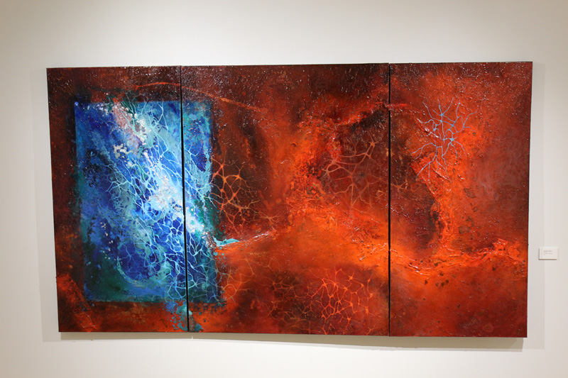 An abstract painting featuring veiny red and blue patterns resembling the texture of stone