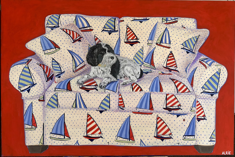 A paintint of a black and white dog lounging on a couch up;holstered with a fabric featuring a pattern of sailboats