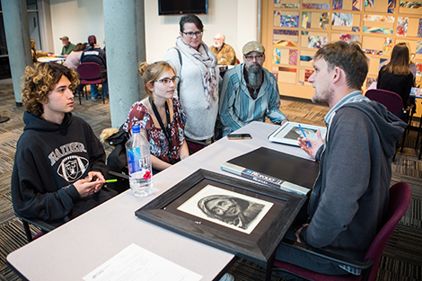 Man giving a young artist feedback on his work