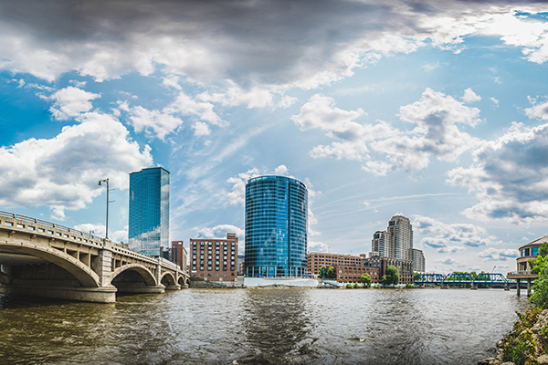 A cityscape with partly cloudy skies overhead