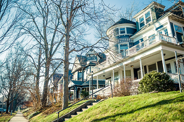 A large historical home, painted blue
