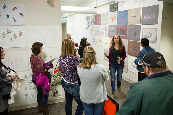 Group of people looking at artwork on the wall