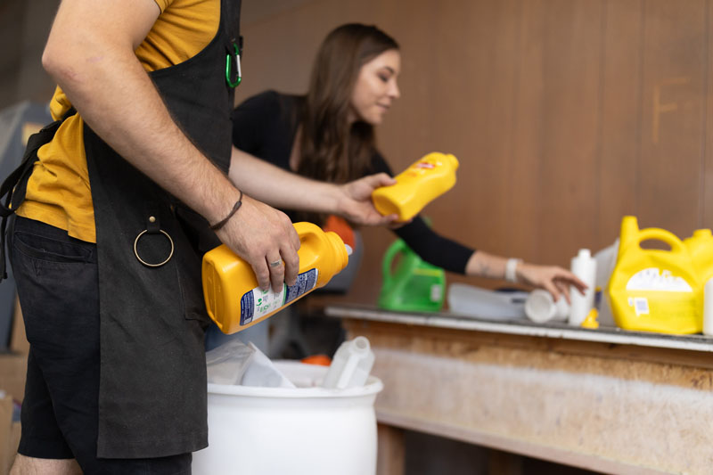 people sorting plastic containers