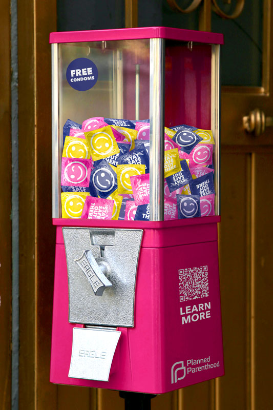 Gumball machine full of wrapped condoms