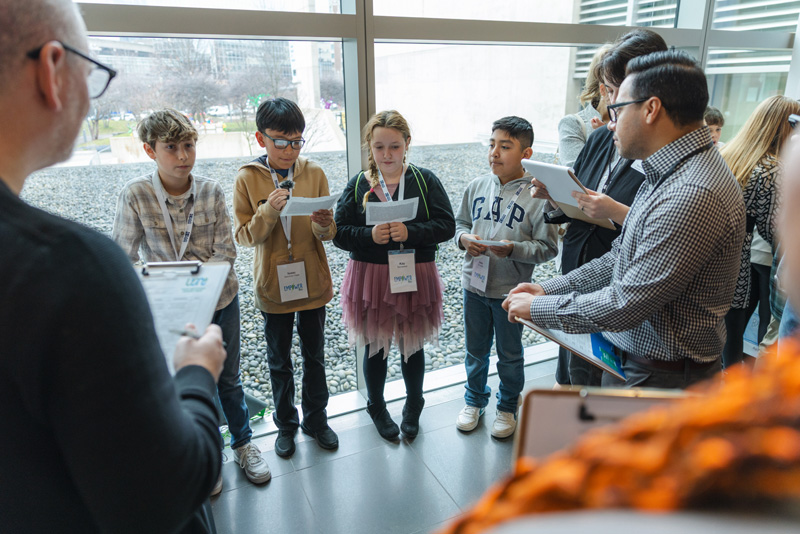 A group of young students presenting a concept product design to a panel of industry professionals