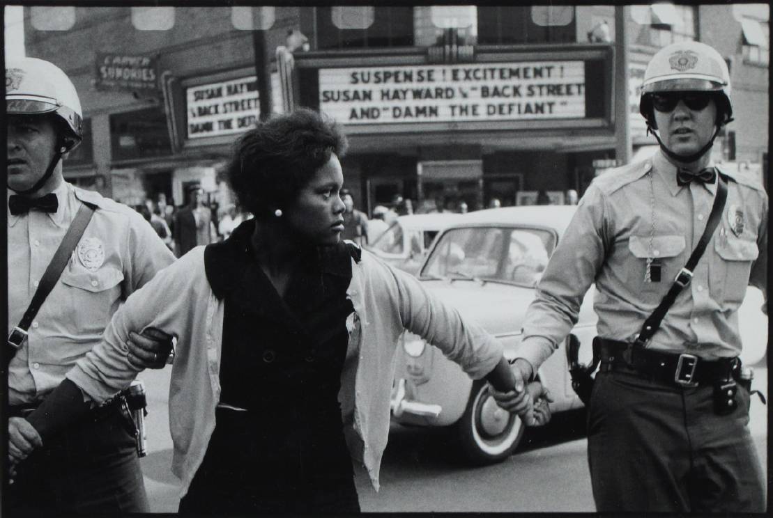 black women being led by two while male officers
