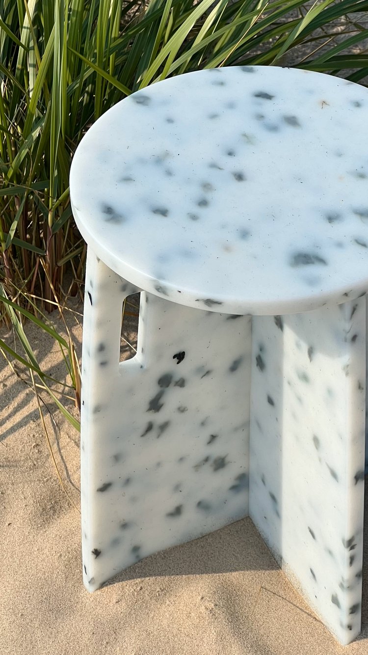 white end table with black specks