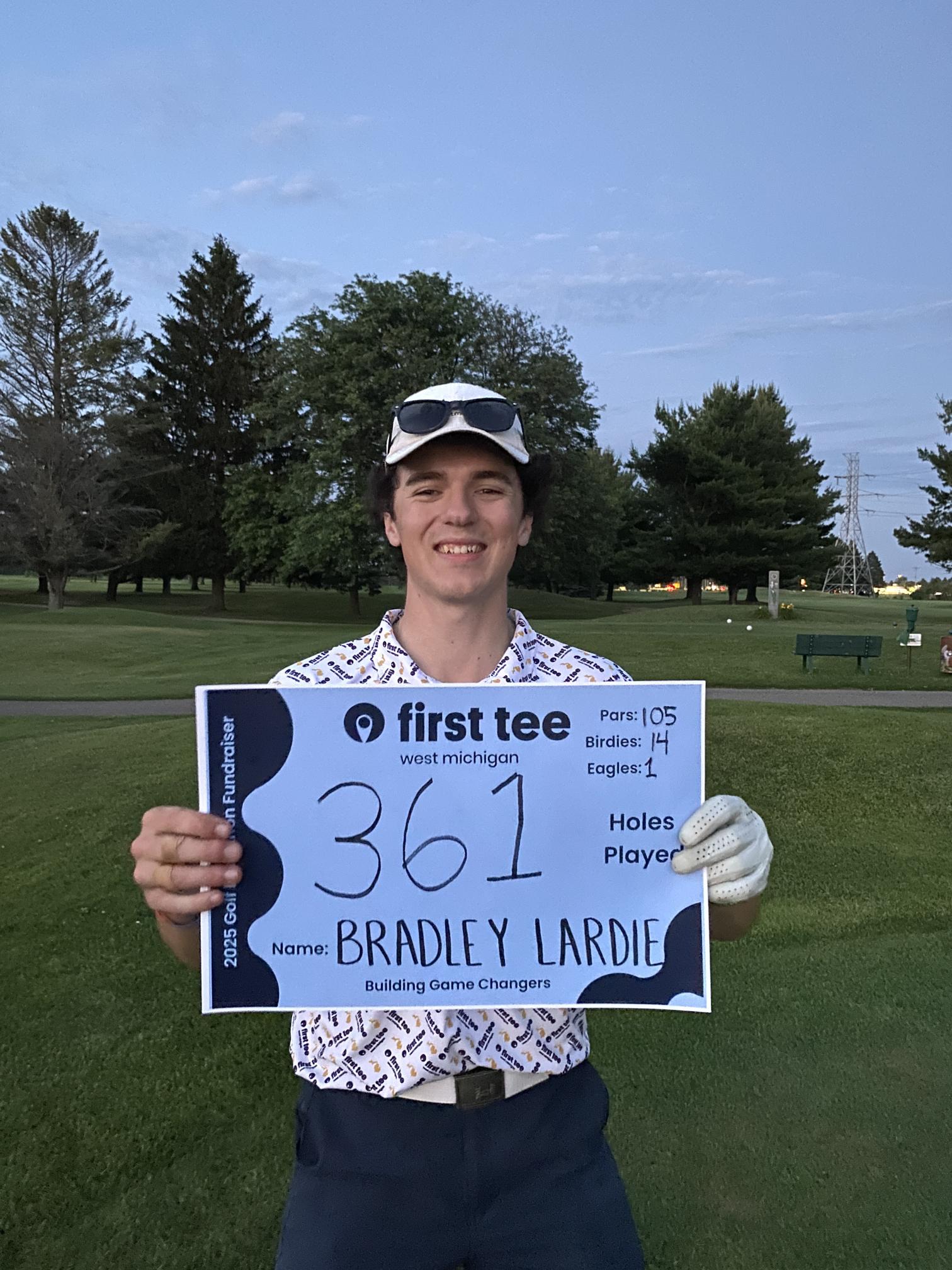 Bradley Lardie Holding a Golf Award