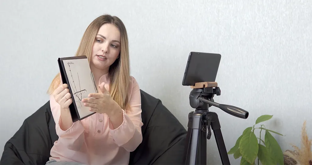 a woman sitting on a chair and explaining something