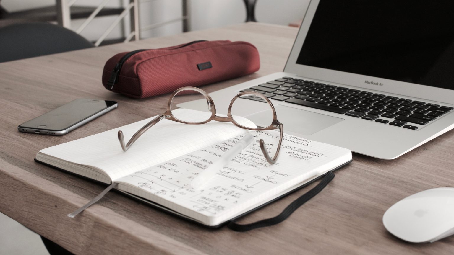 Desk with computer and notebook