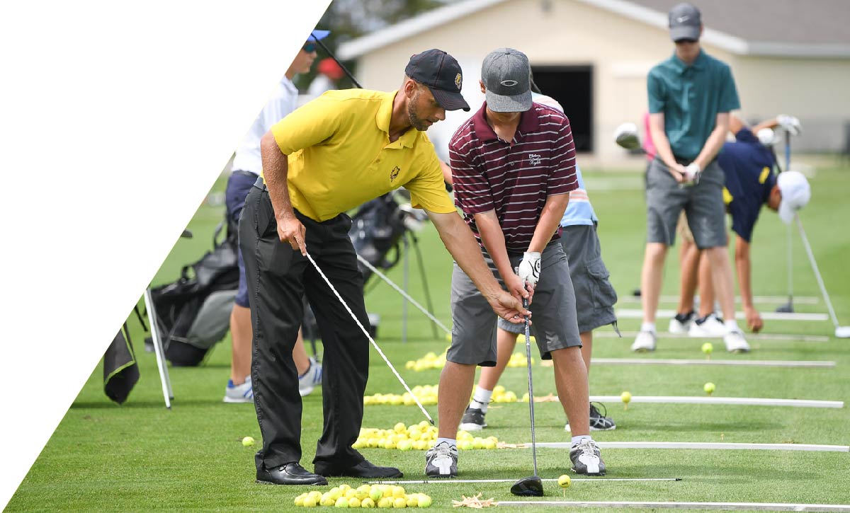 Golf instructor helping student