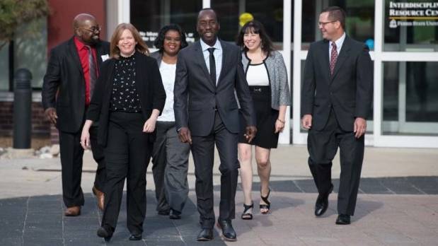 A group of DCCL graduates walking with confidence and smiles on their faces