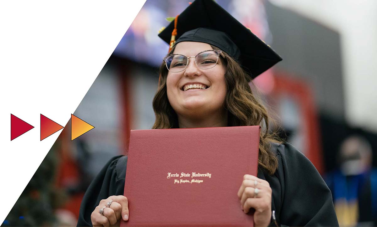 Student with diploma at Ferris State commencement ceremony