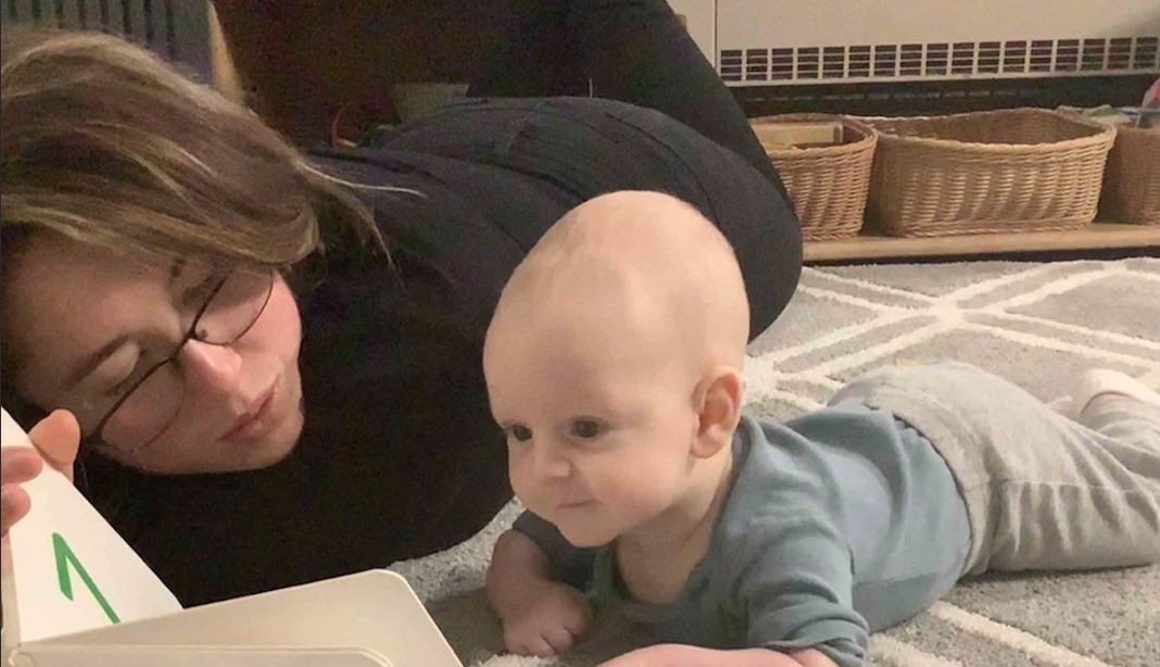 baby reading with teacher