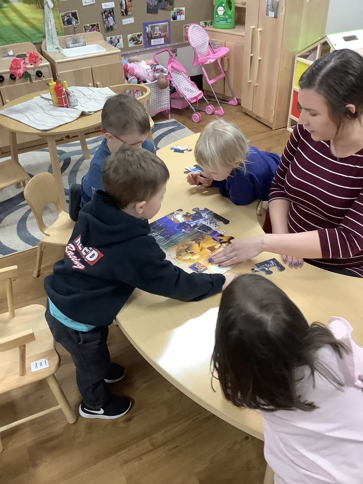 Preschoolers working on puzzle