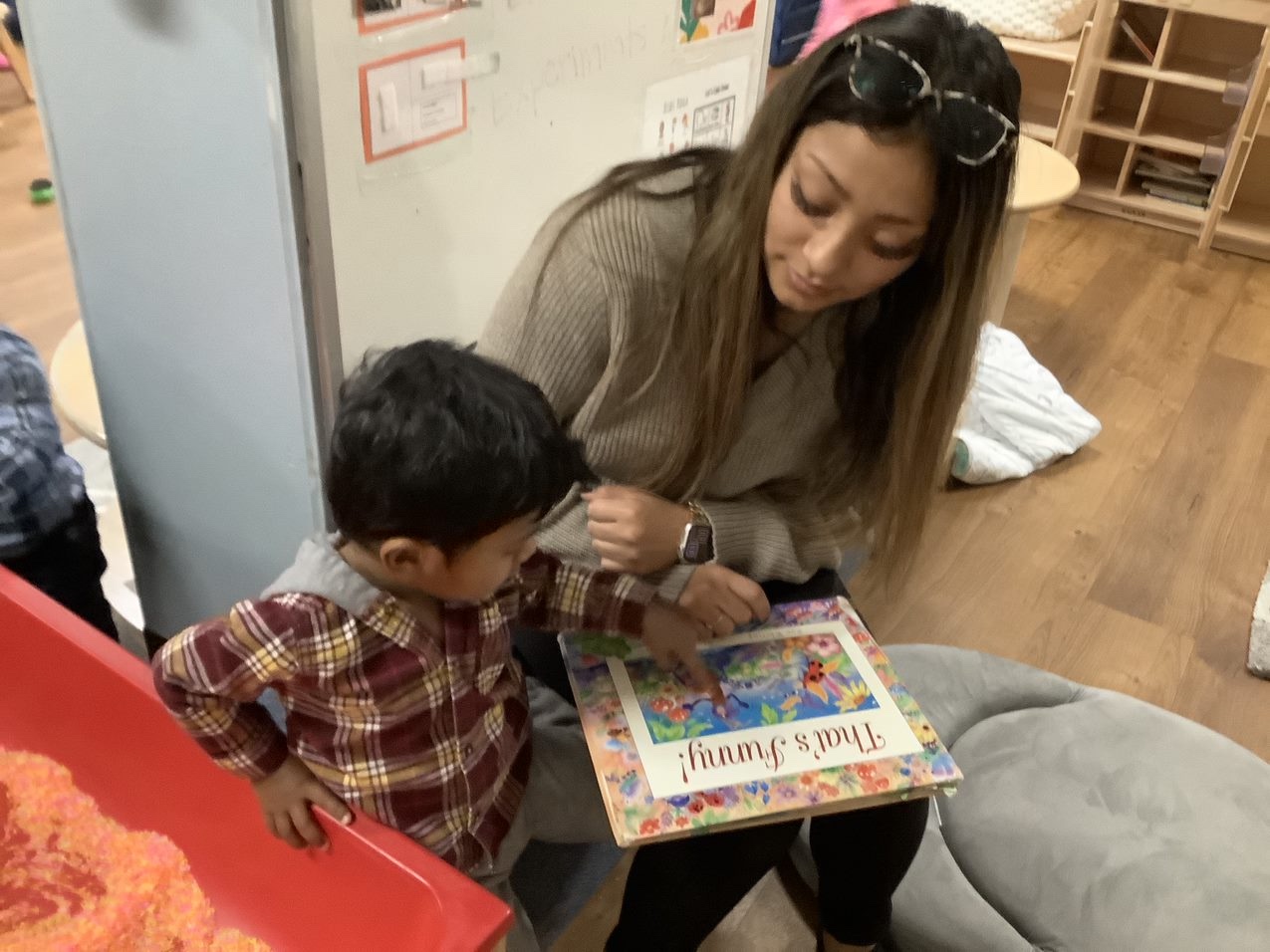 Toddler reading with teacher