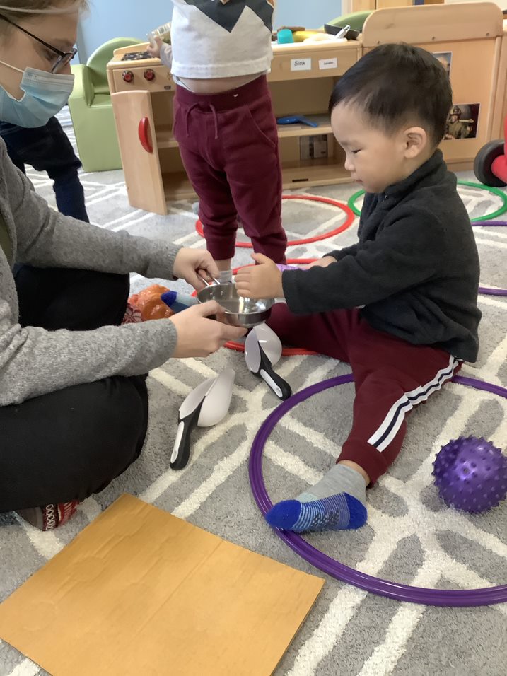 Toddler Playing with teacher