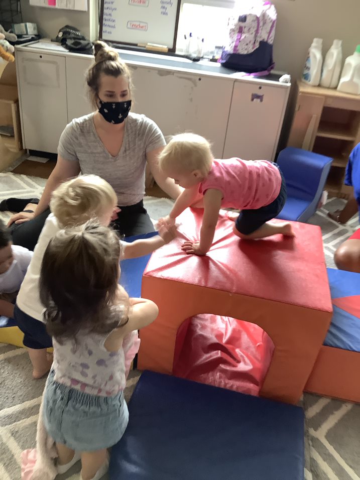 Toddlers playing on foam blocks