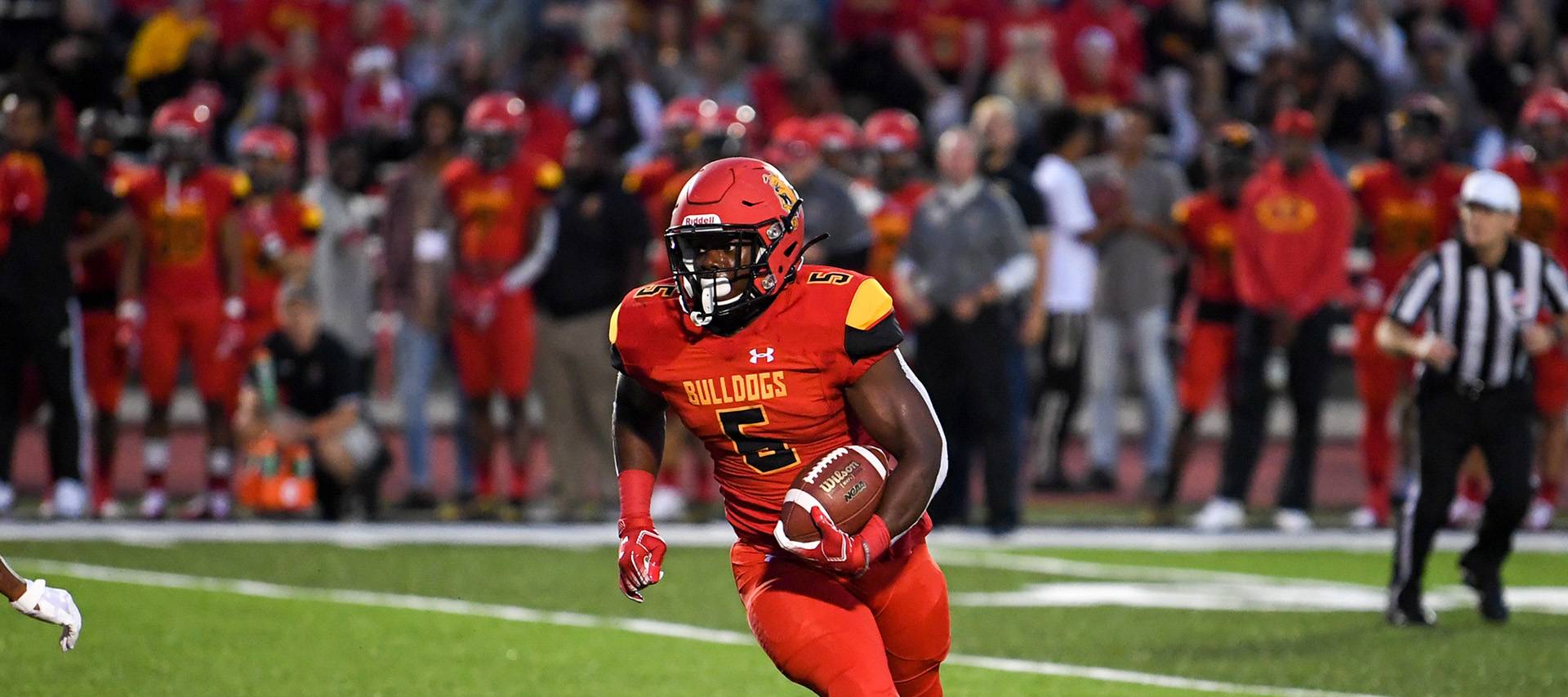 Bulldog football player running with the ball