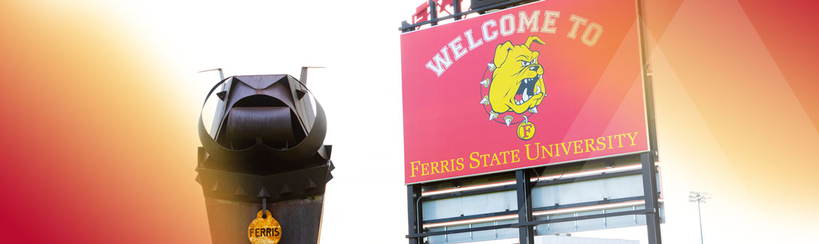 Iron Bulldog statues next to the scoreboard at the football stadium