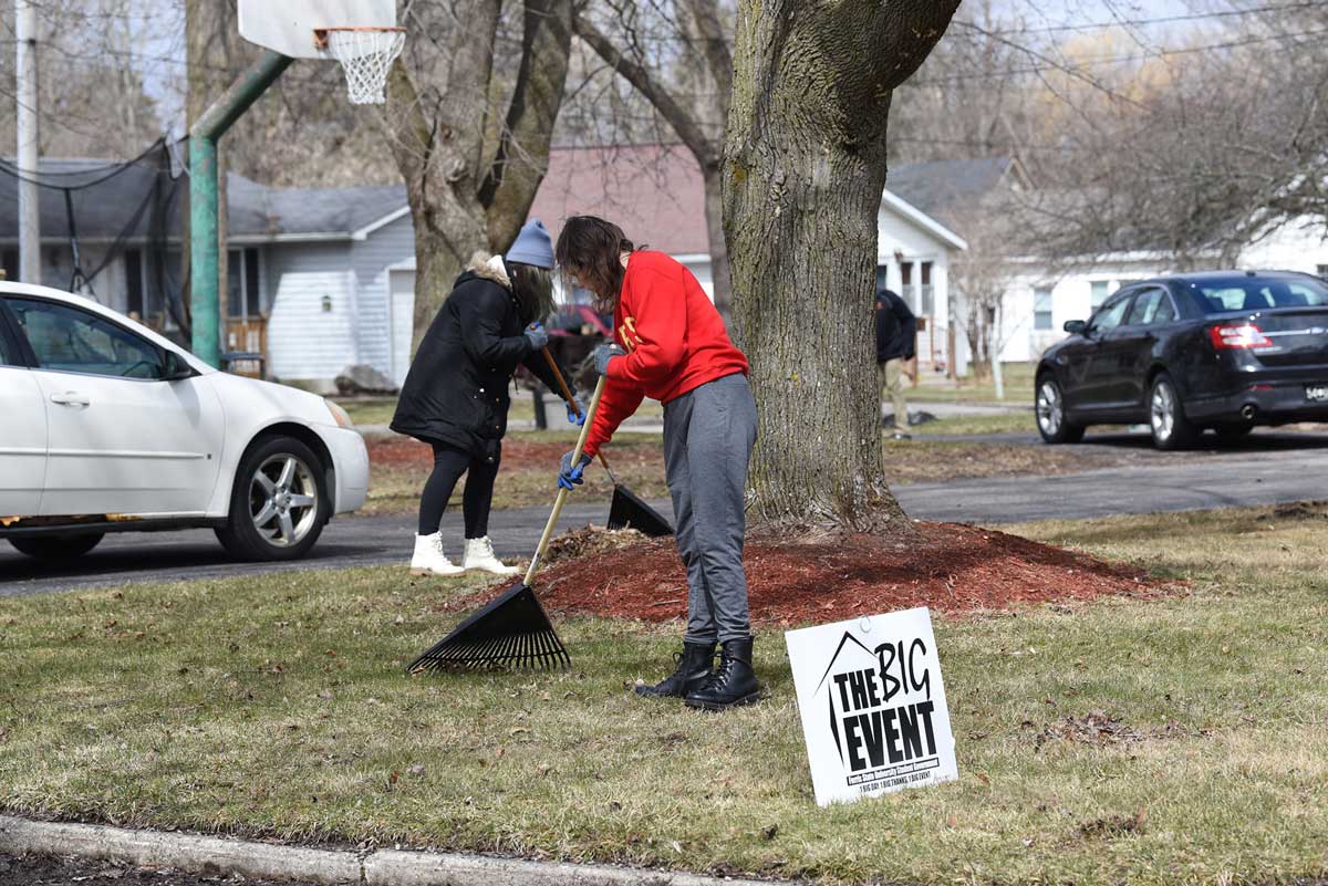 Students rake a neighborhood yard for this year's big event.