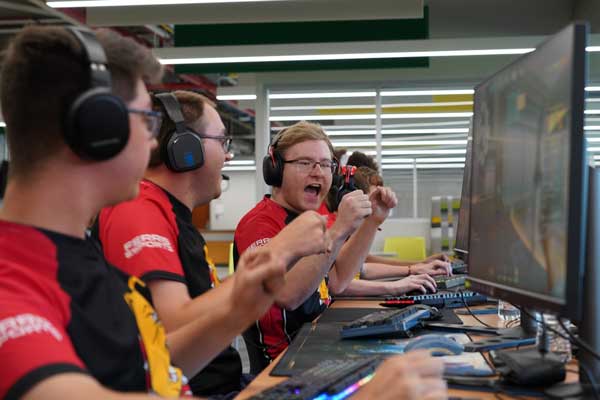 Members of the esports team celebrate a win.