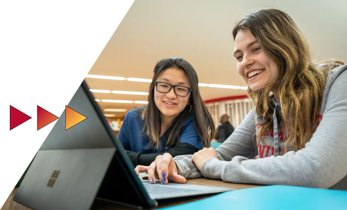 Students working on a laptop.