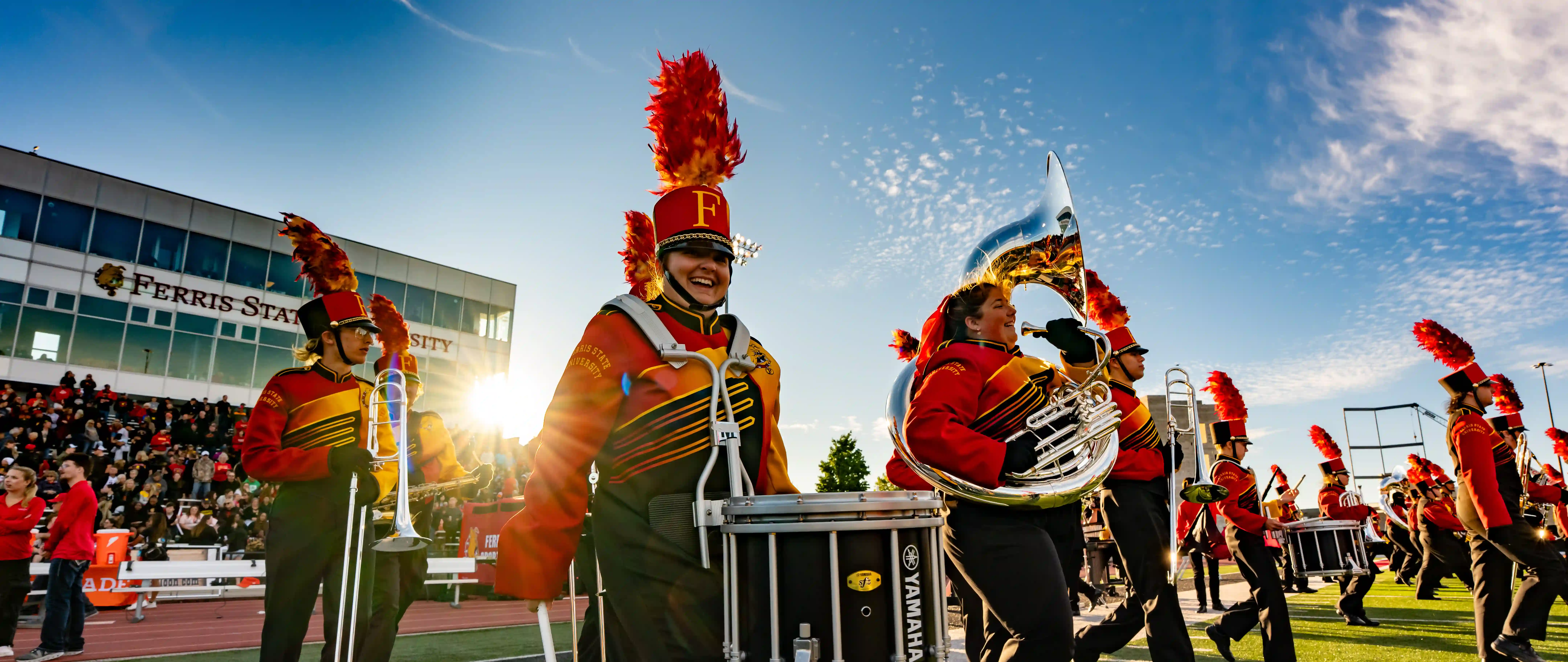 Marching band students walking onto the field