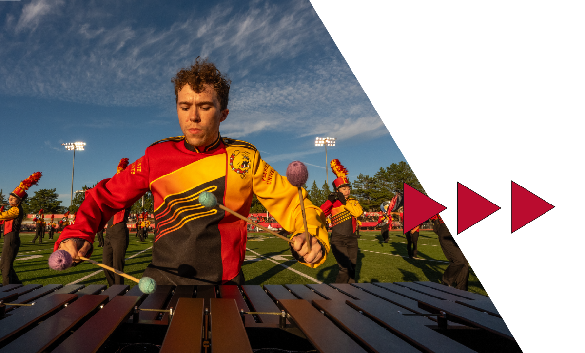 Student playing a xylophone at half-time show.