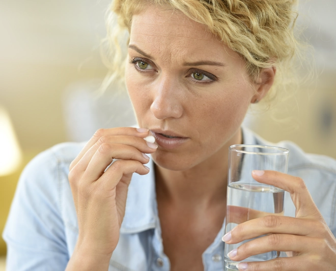 Woman taking antibiotic